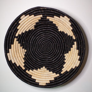 JustOne's wall basket with black star, handwoven in Uganda