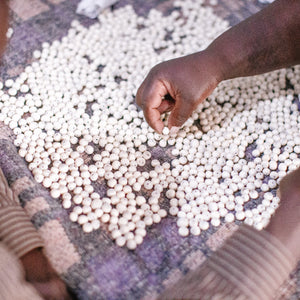 JustOne's bracelet with grey and white beads made from ethically sourced bone and silver rings mixed in, handmade in Kenya