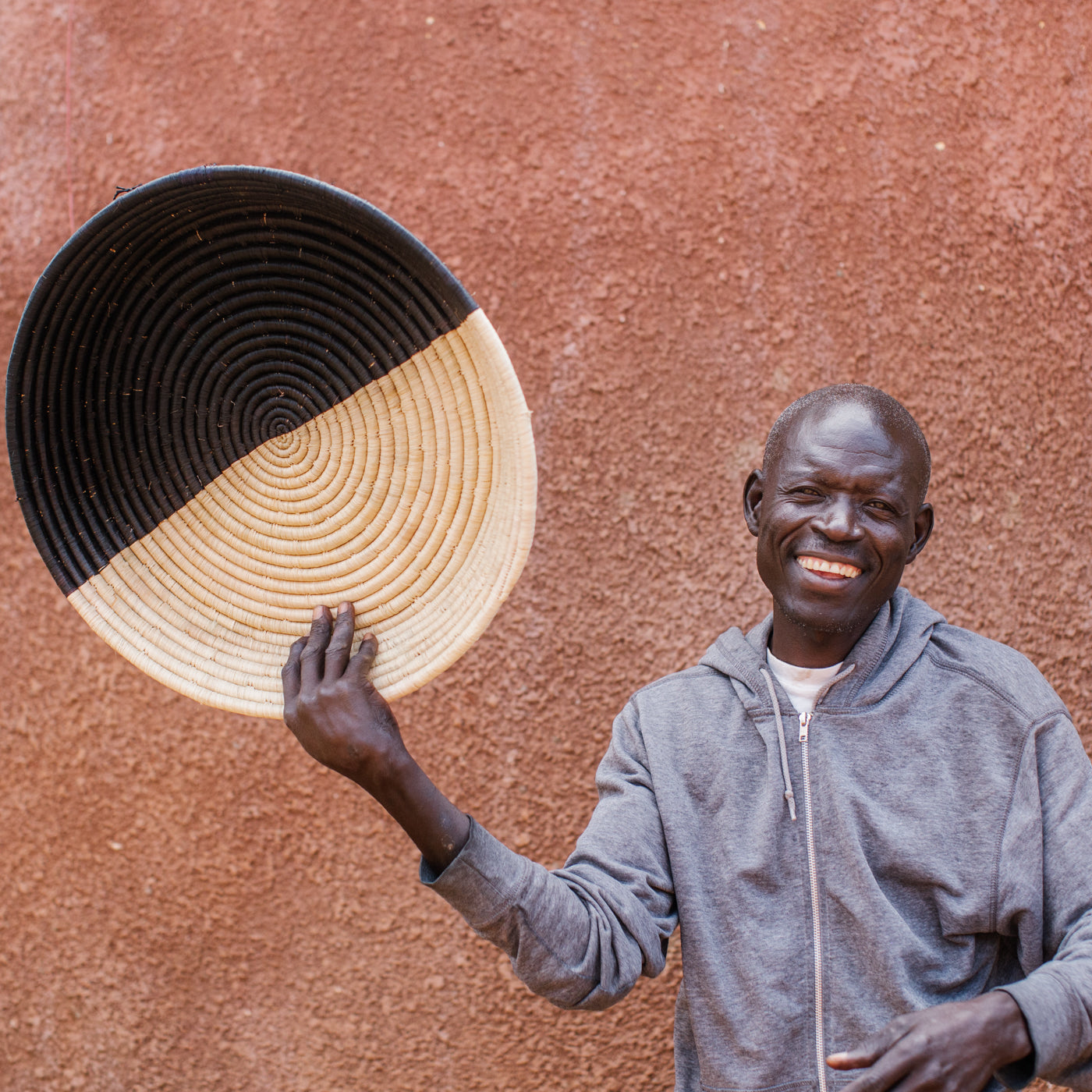 JustOne's half black, half tan wall basket, handwoven in Uganda