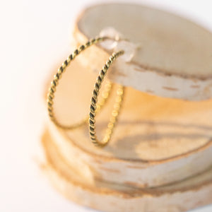 JustOne's brass hoops that has a twist design handcrafted in Kenya